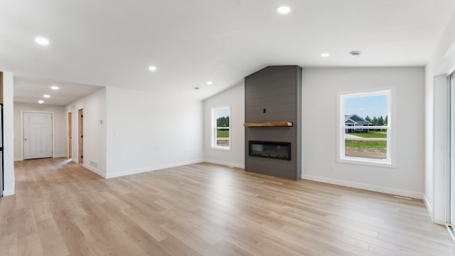 322 Old Glory Dr NE, Alexandria, MN 56308 - unfurnished living room featuring a fireplace, light wood finished floors, recessed lighting, and lofted ceiling