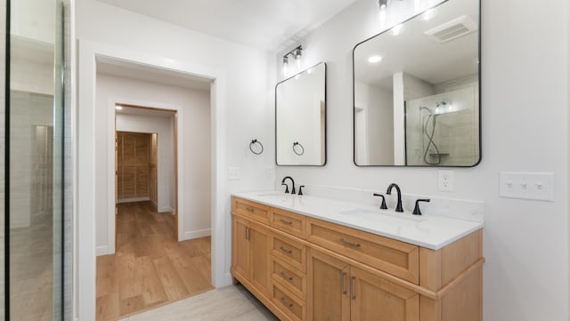322 Old Glory Dr NE, Alexandria, MN 56308 - full bathroom featuring double vanity and wood finished floors