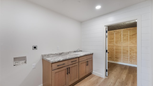 322 Old Glory Dr NE, Alexandria, MN 56308 - laundry area with electric dryer hookup, hookup for a washing machine, light wood-style floors, recessed lighting, and cabinet space