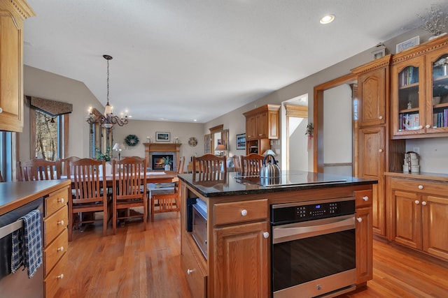 617 17th St N, Sartell, MN 56377 - kitchen featuring appliances with stainless steel finishes, light wood finished floors, a chandelier, pendant lighting, and recessed lighting