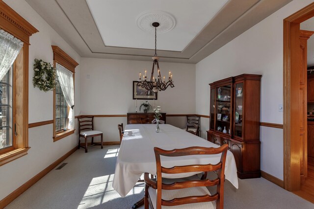 617 17th St N, Sartell, MN 56377 - carpeted dining area featuring a chandelier and a tray ceiling