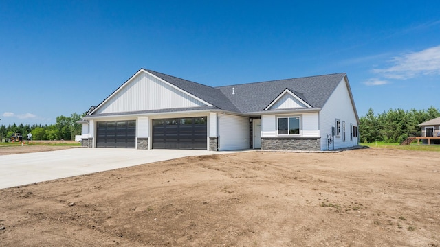 324 Old Glory Dr NE, Alexandria, MN 56308 - modern farmhouse featuring stone siding, an attached garage, driveway, and a shingled roof