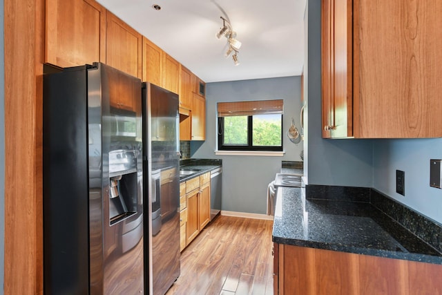 3131 Excelsior Blvd Unit 508, Minneapolis, MN 55416 - kitchen featuring stainless steel appliances, brown cabinets, light wood-type flooring, dark stone countertops, and rail lighting