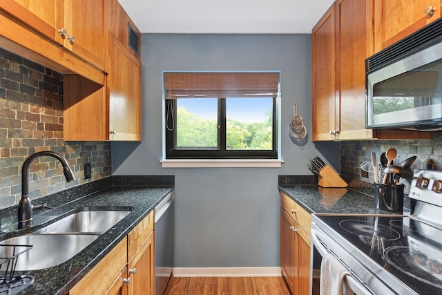 3131 Excelsior Blvd Unit 508, Minneapolis, MN 55416 - kitchen featuring stainless steel appliances, tasteful backsplash, light wood-type flooring, and brown cabinetry