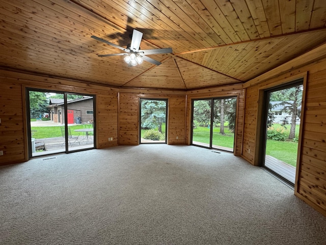 605 Arbor Ct, Marshall, MN 56258 - unfurnished room with wood ceiling, wood walls, vaulted ceiling, carpet floors, and ceiling fan