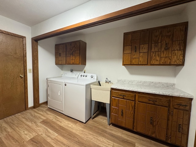 605 Arbor Ct, Marshall, MN 56258 - laundry room featuring cabinet space, independent washer and dryer, and light wood finished floors