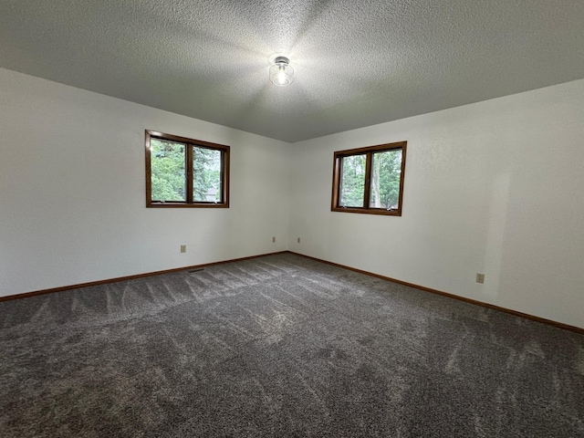 605 Arbor Ct, Marshall, MN 56258 - carpeted empty room with baseboards and a textured ceiling