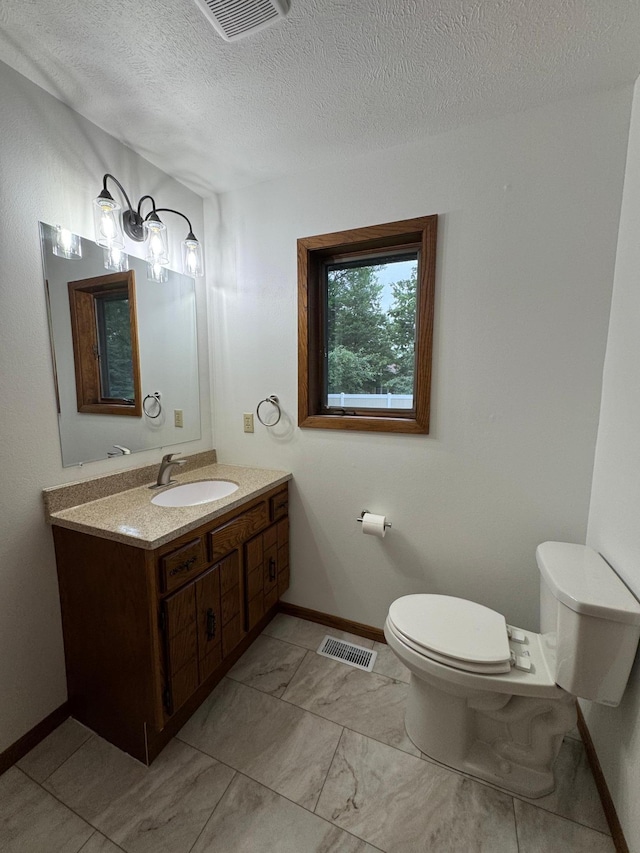 605 Arbor Ct, Marshall, MN 56258 - bathroom featuring vanity, a textured ceiling, and marble finish flooring