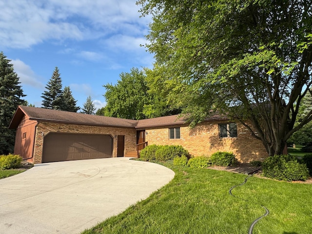 605 Arbor Ct, Marshall, MN 56258 - ranch-style house featuring a garage, driveway, brick siding, and a front lawn