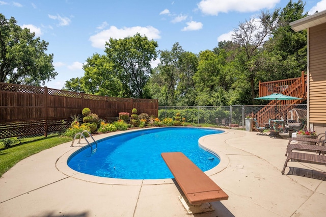 2217 73rd Ct N, Brooklyn Park, MN 55444 - view of pool featuring a fenced backyard, a patio, a diving board, and view of scattered trees