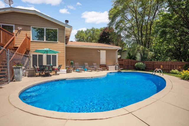 2217 73rd Ct N, Brooklyn Park, MN 55444 - view of swimming pool featuring a patio and stairway
