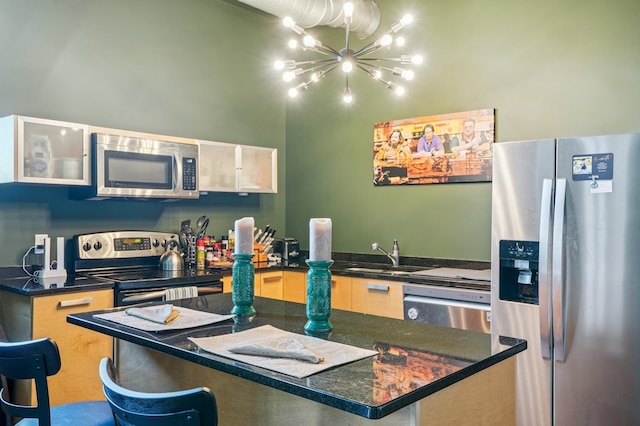 350 Saint Peter St Unit 1110, Saint Paul, MN 55102 - kitchen featuring stainless steel appliances, a chandelier, dark countertops, and a breakfast bar