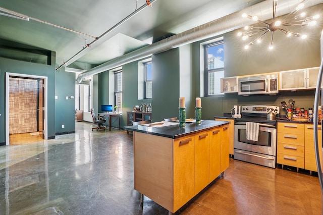350 Saint Peter St Unit 1110, Saint Paul, MN 55102 - kitchen with stainless steel appliances, dark countertops, and plenty of natural light