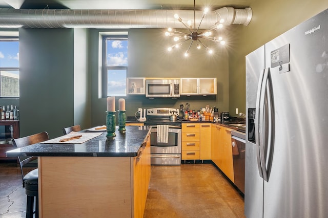 350 Saint Peter St Unit 1110, Saint Paul, MN 55102 - kitchen with appliances with stainless steel finishes, concrete flooring, a chandelier, dark countertops, and a kitchen island