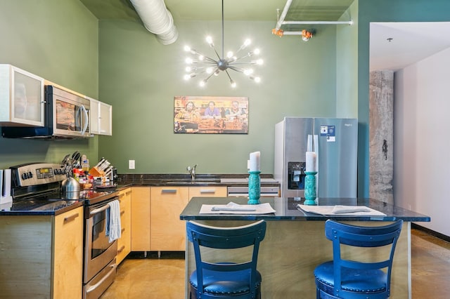 350 Saint Peter St Unit 1110, Saint Paul, MN 55102 - kitchen with appliances with stainless steel finishes, a chandelier, finished concrete floors, a breakfast bar area, and light brown cabinetry