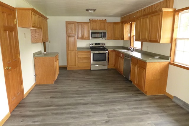 N6217 Kirk Rd, Durand, WI 54736 - kitchen featuring stainless steel appliances, healthy amount of natural light, wood finished floors, and brown cabinetry