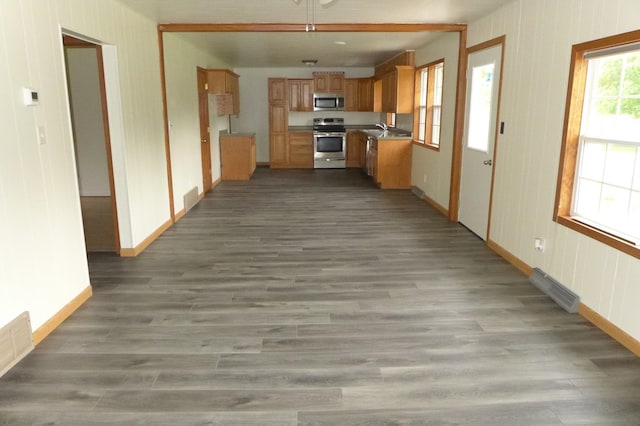 N6217 Kirk Rd, Durand, WI 54736 - kitchen featuring stainless steel appliances, wood finished floors, and brown cabinetry