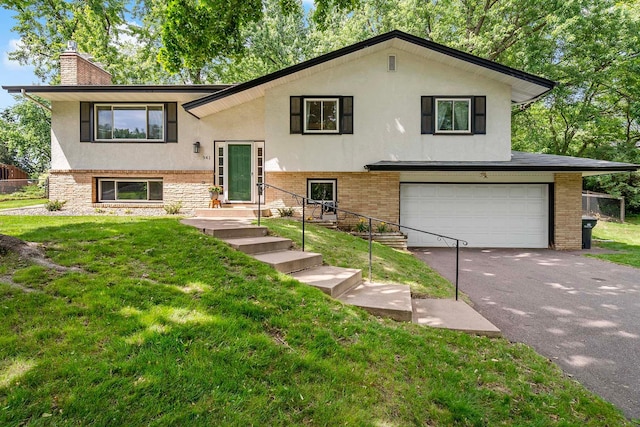 941 Cannon Ave, Shoreview, MN 55126 - split foyer home featuring an attached garage, stucco siding, driveway, and brick siding