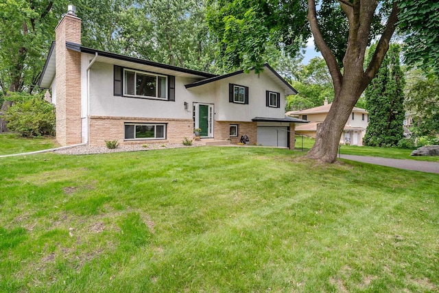 941 Cannon Ave, Shoreview, MN 55126 - raised ranch featuring a chimney, stucco siding, a garage, and a front lawn