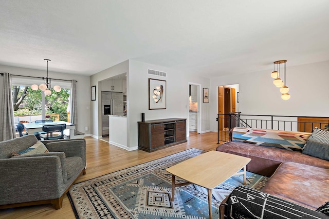 941 Cannon Ave, Shoreview, MN 55126 - living room with light wood-style floors and a chandelier