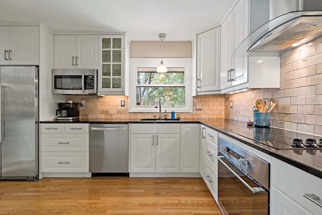 941 Cannon Ave, Shoreview, MN 55126 - kitchen featuring stainless steel appliances, wall chimney exhaust hood, dark countertops, and white cabinets