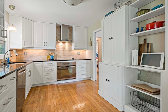941 Cannon Ave, Shoreview, MN 55126 - kitchen with appliances with stainless steel finishes, wall chimney exhaust hood, open shelves, light wood finished floors, and white cabinetry