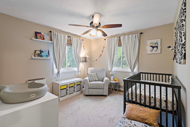 941 Cannon Ave, Shoreview, MN 55126 - bedroom featuring a crib, light carpet, and a ceiling fan