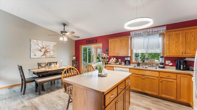 234 17th Ave SE, Saint Joseph, MN 56374 - kitchen featuring plenty of natural light, light countertops, light wood finished floors, brown cabinets, and vaulted ceiling