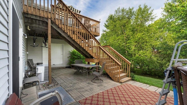 234 17th Ave SE, Saint Joseph, MN 56374 - view of patio with stairway, a deck, and outdoor dining space