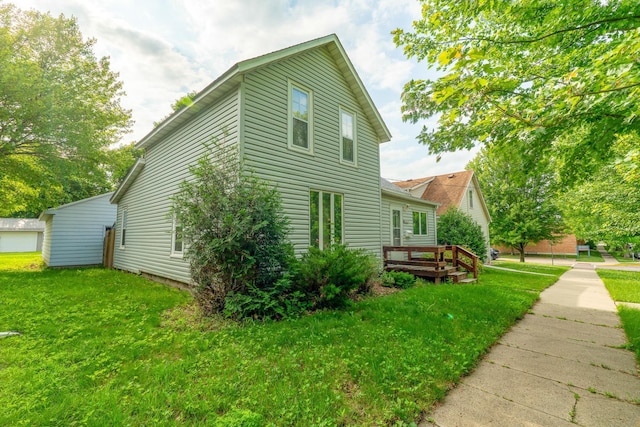 421 Moore St, Blue Earth, MN 56013 - view of property exterior featuring a lawn and a deck