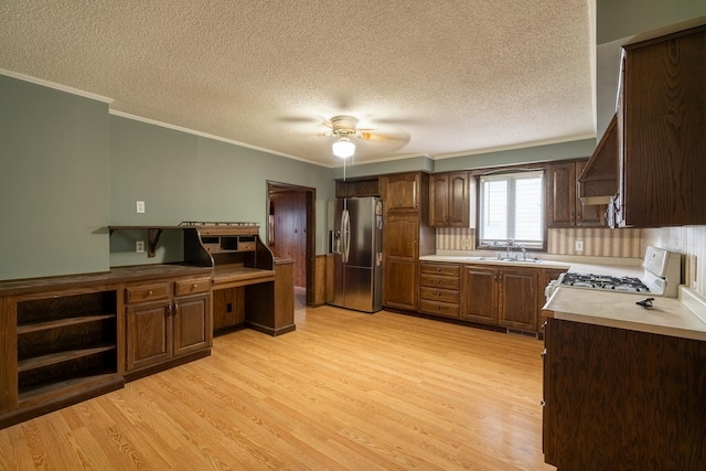 421 Moore St, Blue Earth, MN 56013 - kitchen featuring stainless steel fridge with ice dispenser, ornamental molding, light wood-style floors, white range with gas stovetop, and a textured ceiling
