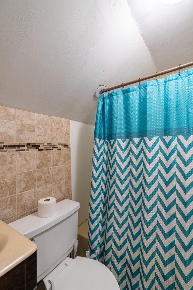 421 Moore St, Blue Earth, MN 56013 - bathroom featuring tile walls, shower / bath combo, and vanity