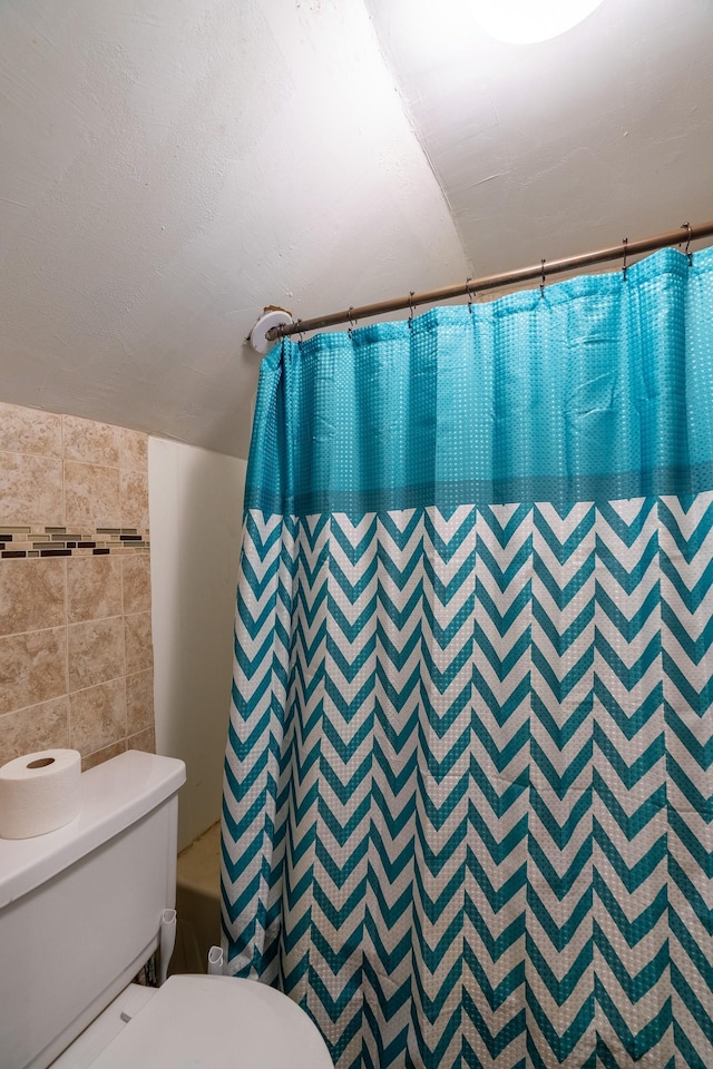 421 Moore St, Blue Earth, MN 56013 - bathroom featuring tile walls and shower / tub combo with curtain