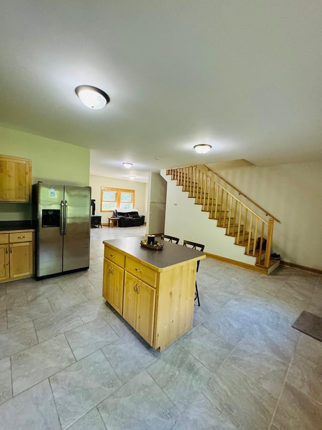 2795 40th St NW, Hackensack, MN 56452 - kitchen featuring stainless steel fridge, dark countertops, and a kitchen island