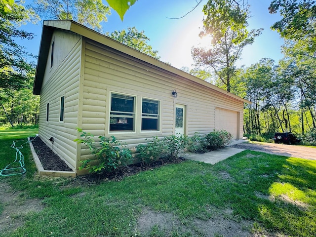 2795 40th St NW, Hackensack, MN 56452 - view of side of home with log veneer siding, a yard, driveway, and a garage