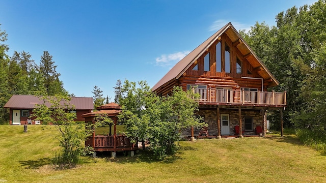 2338 Olson Rd, Blackhoof Twp, MN 55718 - rear view of house featuring a gazebo, stone siding, a lawn, a wooden deck, and a metal roof