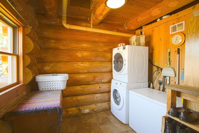 2338 Olson Rd, Blackhoof Twp, MN 55718 - laundry area featuring log walls, stacked washer / drying machine, wood ceiling, and stone finish flooring
