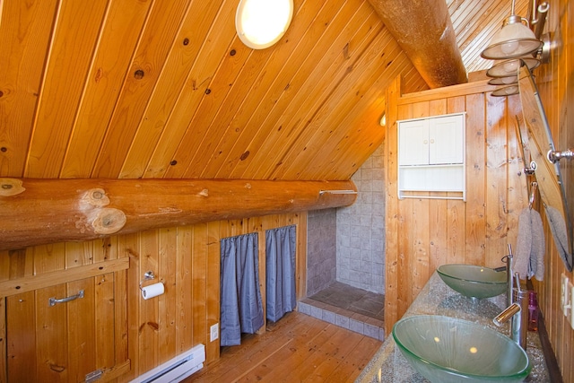 2338 Olson Rd, Blackhoof Twp, MN 55718 - bathroom with wooden walls, hardwood / wood-style flooring, tiled shower, and double vanity