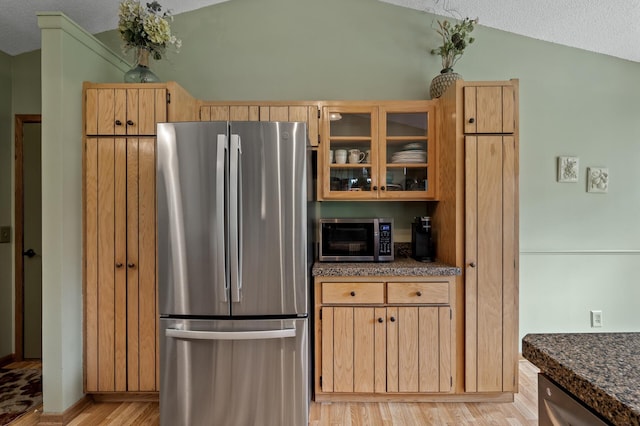 6469 Deerwood Ln N, Maple Grove, MN 55369 - kitchen featuring appliances with stainless steel finishes, light wood-type flooring, vaulted ceiling, glass insert cabinets, and dark stone counters