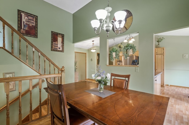 6469 Deerwood Ln N, Maple Grove, MN 55369 - dining room with a chandelier, high vaulted ceiling, wood finished floors, and stairs