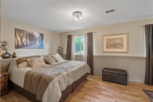 6469 Deerwood Ln N, Maple Grove, MN 55369 - bedroom featuring light wood finished floors and a textured ceiling
