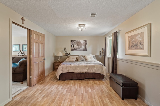 6469 Deerwood Ln N, Maple Grove, MN 55369 - bedroom featuring light wood-type flooring and a textured ceiling