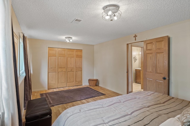 6469 Deerwood Ln N, Maple Grove, MN 55369 - bedroom with wood finished floors, a closet, and a textured ceiling