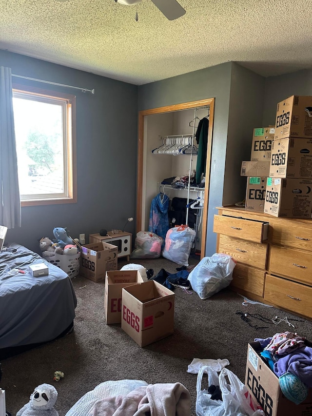 11162 Olympia Ave, Becker, MN 55308 - bedroom featuring carpet floors, a closet, a textured ceiling, and a ceiling fan