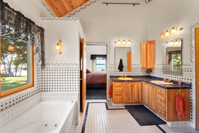 2282 71st St, Georgetown Twp, WI 54853 - full bathroom with double vanity, tile patterned flooring, a tub with jets, healthy amount of natural light, and lofted ceiling