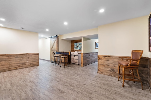 2282 71st St, Georgetown Twp, WI 54853 - bar with a barn door, wood finished floors, and recessed lighting