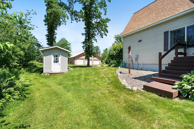 2282 71st St, Georgetown Twp, WI 54853 - view of green lawn featuring an outdoor structure and a garage
