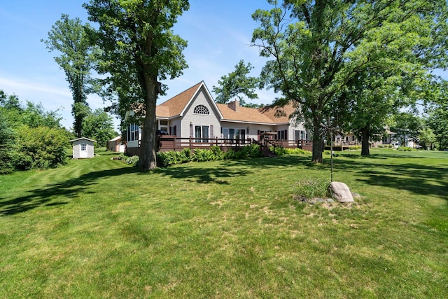 2282 71st St, Georgetown Twp, WI 54853 - view of green lawn featuring a wooden deck and a shed