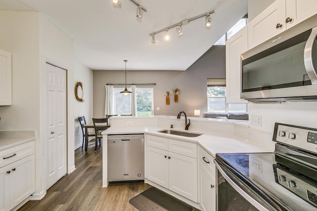 16835 78th Pl N, Maple Grove, MN 55311 - kitchen featuring appliances with stainless steel finishes, a peninsula, white cabinets, and light countertops