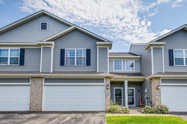 16835 78th Pl N, Maple Grove, MN 55311 - view of property featuring a garage, driveway, and brick siding